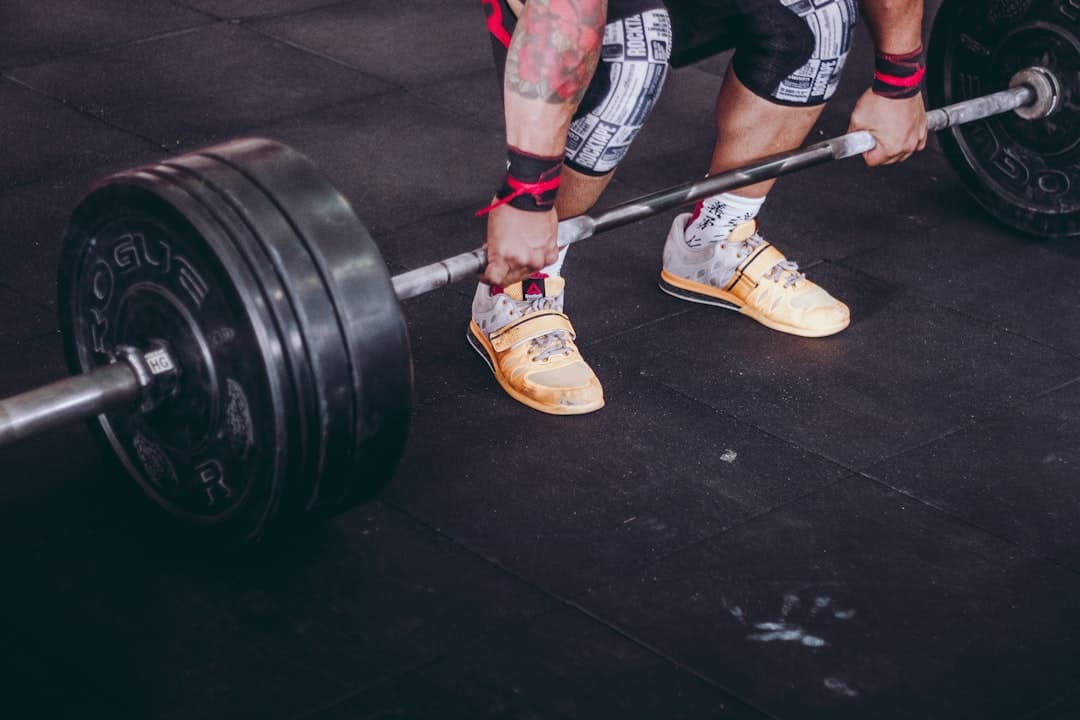 A person holding a loaded barbell