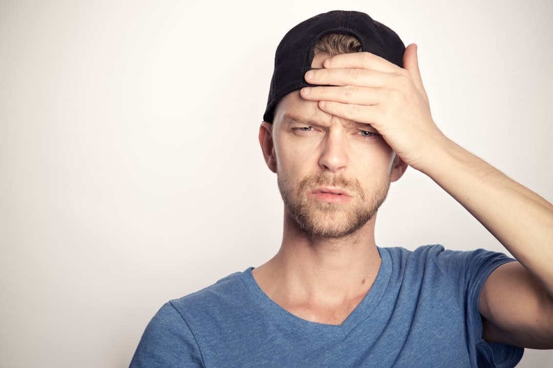 A person covering their face with their hand