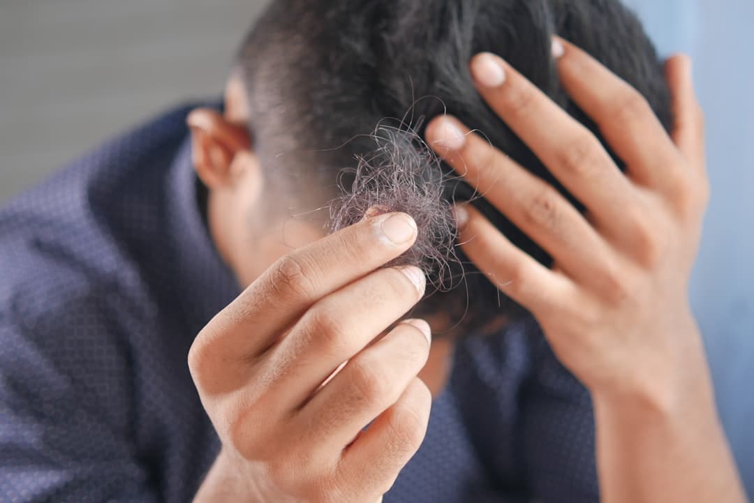 A man examining his hair