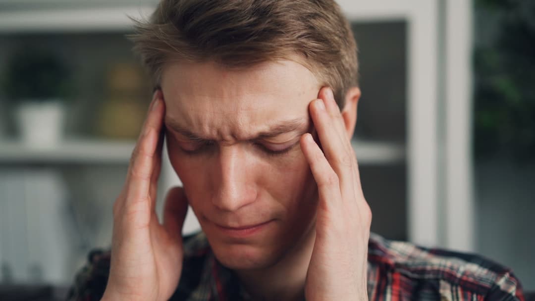 A person experiencing head pain