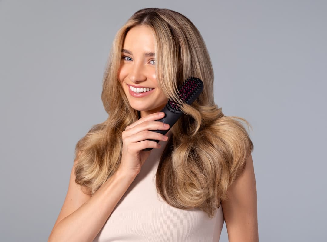 A person holding a hairbrush