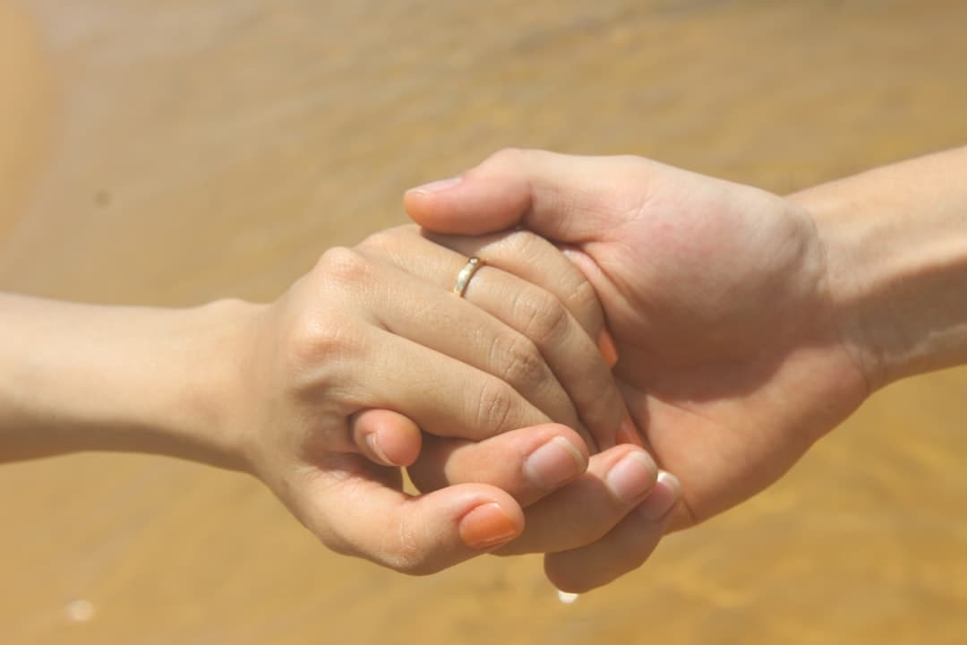 Two people holding hands