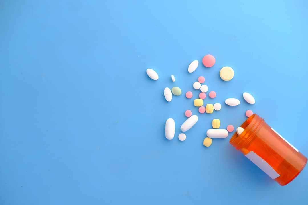 An orange and white medication pill