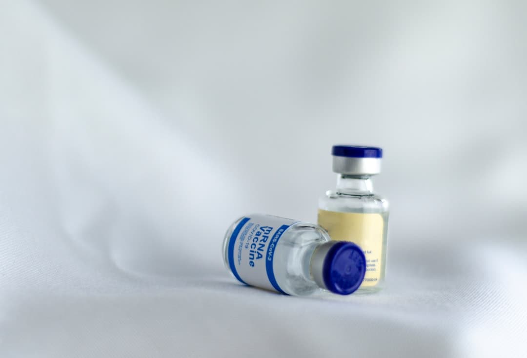A medication bottle with a white and blue label.