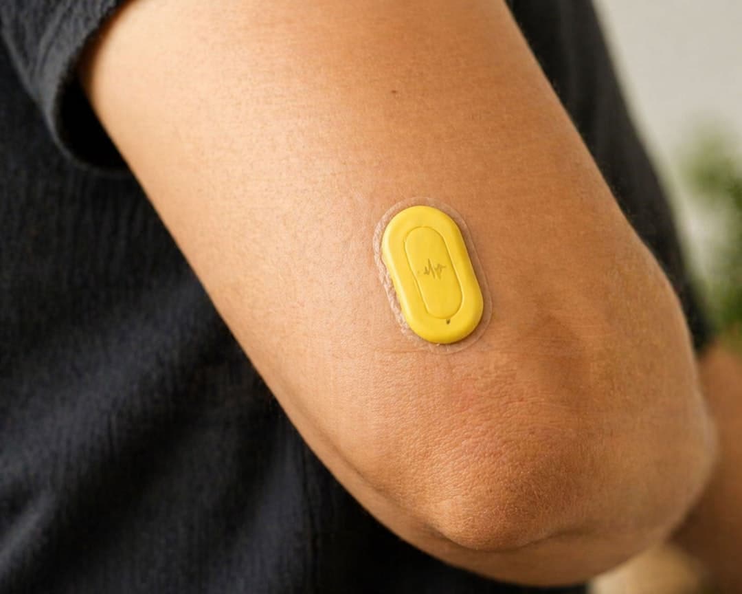 A medical sensor patch on a person's arm