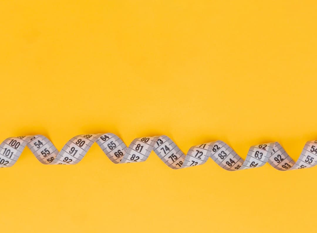 A measuring tape on a yellow background